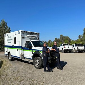 Two of our EMT's standing in front of an ambulance.